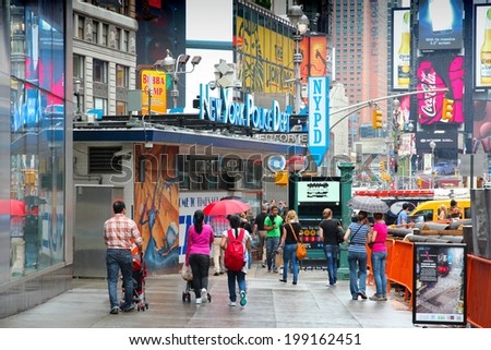 NEW YORK, USA - JULY 1, 2013: People visit Times Square in New York. Times Square is one of most recognized landmarks in the world. More than 300,000 people pass through Times Square daily.