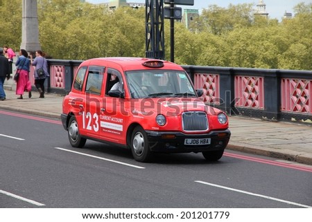 LONDON, UK - MAY 13, 2012: Taxi cab drives in London. As of 2012, there were 24,000 licensed taxi cabs in London.