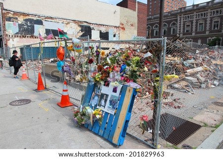 PHILADELPHIA, USA - JUNE 11, 2013: Person visits building collapse memorial in Philadelphia. The unoccupied building collapsed during demolition on June 5, 2013 killing 6 and injuring 14 people.
