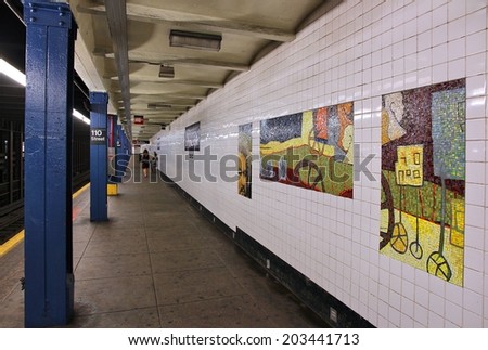 NEW YORK, USA - JULY 2, 2013: People wait at a subway station in New York. With 1.67 billion annual rides, New York City Subway is the 7th busiest metro system in the world.