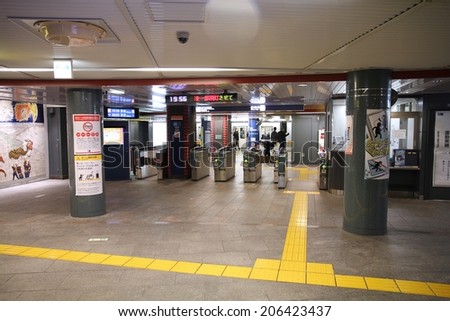 TOKYO, JAPAN - APRIL 13, 2012: People enter Tokyo Metro. With more than 3.1 billion annual passenger rides, Tokyo subway system is the busiest worldwide.