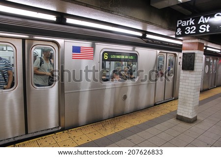 NEW YORK, USA - JULY 3, 2013: People ride a subway train in New York. With 1.67 billion annual rides, New York City Subway is the 7th busiest metro system in the world.