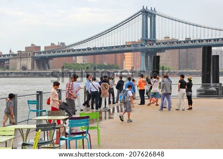NEW YORK, USA - JULY 3, 2013: People take photos of Manhattan Bridge in New York. Almost 19 million people live in New York City metropolitan area.
