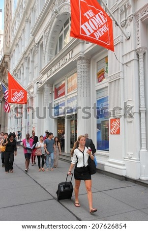 NEW YORK, USA - JULY 3, 2013: People walk by Home Depot in New York. Home Depot is a retailer of home improvement and construction products. It has 2,248 stores in the USA (2011).