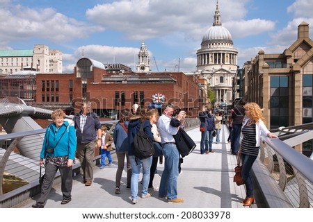 LONDON, UK - MAY 13, 2012: People walk the Millennium Bridge in London. With more than 14 million international arrivals in 2009, London is the most visited city in the world (Euromonitor).