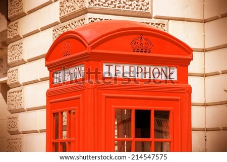 London, United Kingdom - red telephone box close-up. Cross processing color tone - filtered retro style.