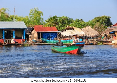 TONLE SAP, CAMBODIA - DECEMBER 11, 2013: Unidentified people go about their daily life in floating village on Tonle Sap lake. It is the largest lake in Southeast Asia (up to 16,000 square km).