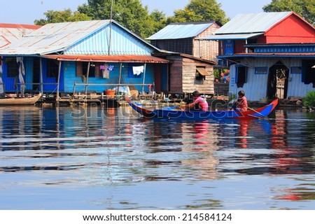 TONLE SAP, CAMBODIA - DECEMBER 11, 2013: Unidentified people go about their daily life in floating village on Tonle Sap lake. It is the largest lake in Southeast Asia (up to 16,000 square km).