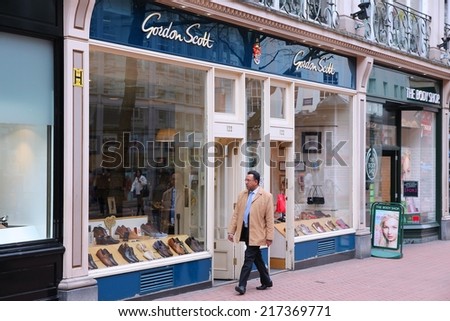 BIRMINGHAM, UK - APRIL 19, 2013: Person walks by Gordon Scott shoe store in Birmingham, UK. Gordon Scott is a brand of Jones Bootmaker (100 locations in the UK), company founded in 1857.