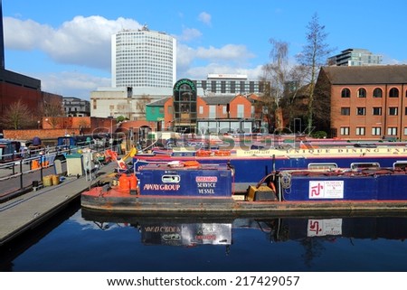 BIRMINGHAM, UK - APRIL 19, 2013: Narrowboats moored at Gas Street Basin in Birmingham, UK. Birmingham is the 2nd most populous British city. It has rich waterway and boat culture.