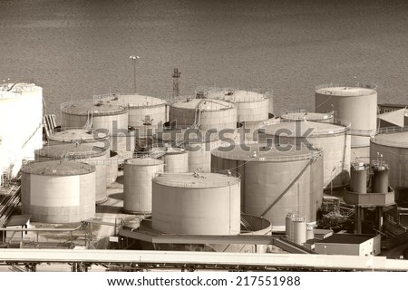 Oil tanks and other silos at Stockholm sea port. Sweden. Sepia tone - retro monochrome color style.