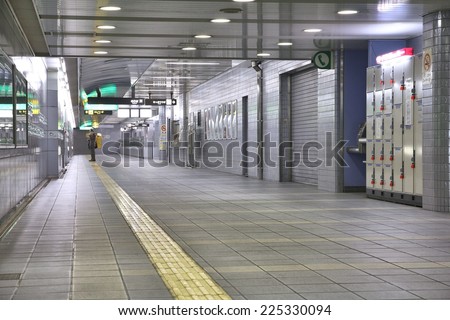 OSAKA, JAPAN - APRIL 25, 2012: Person waiting at Osaka Subway station in Osaka, Japan. Osaka Subway is 12th busiest metro system worldwide with 837 million annual ridership (2010).