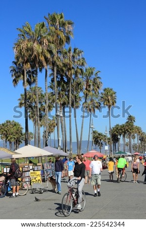 VENICE, UNITED STATES - APRIL 6, 2014: People visit Ocean Front Walk at Venice Beach, California. Venice Beach is one of most popular beaches of LA County. 9.8 million people live in LA County.