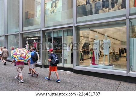 NEW YORK, USA - JULY 1, 2013: People walk by Elie Tahari store in 5th Avenue, New York. Elie Tahari is an Iranian-American fashion designer and his brand brings USD 500 million in annual revenue.