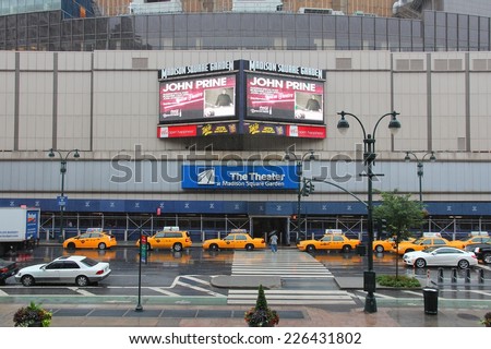 NEW YORK, USA - JULY 1, 2013: People walk by rainy Madison Square Garden in New York. MSG is one of most popular multi-purpose indoor arenas in NY. It dates back to 1964.