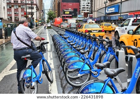 NEW YORK, USA - JULY 1, 2013: Man uses Citibike bicycle sharing station in New York. With 330 stations and 6,000 bicycles it is one of top 10 bike sharing systems in the world.