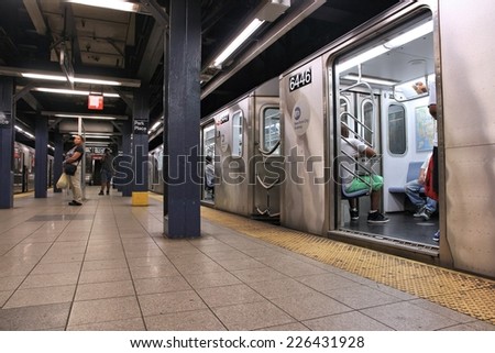 NEW YORK, USA - JULY 1, 2013: People ride a subway train in New York. With 1.67 billion annual rides, New York City Subway is the 7th busiest metro system in the world.