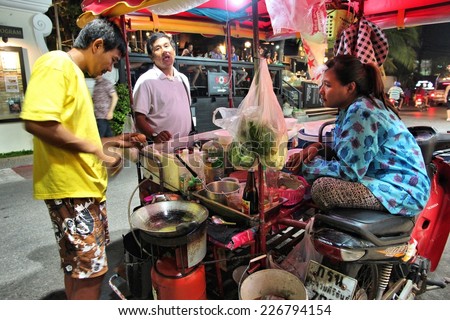 HUA HIN, THAILAND - DECEMBER 13, 2013: Person cooks typical street food in Thailand. 26.7 million people visited Thailand in 2013, some of them to enjoy Thai cuisine.
