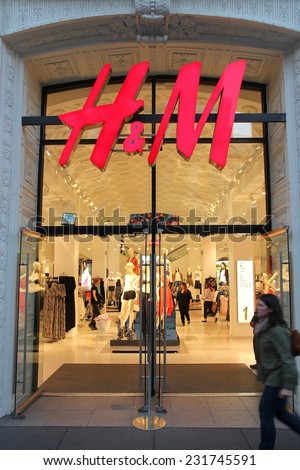 SAN FRANCISCO, USA - APRIL 8, 2014: Shopper walks by H&M fashion store in San Francisco, USA. H&M was founded in 1947, it employs 87,000 people.
