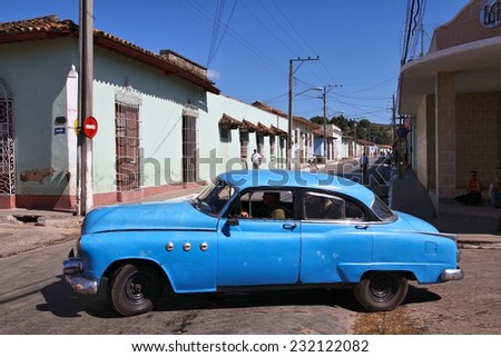 TRINIDAD, CUBA - FEBRUARY 6, 2011: Person drives old car in Trinidad. Cuba has one of the lowest car-per-capita rates (38 per 1000 people in 2008).