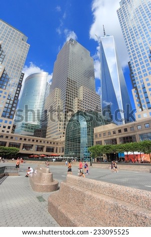 NEW YORK, USA - JULY 4, 2013: People walk near One World Trade Center skyscraper in New York. The building opened in 2014. It is 541m tall.