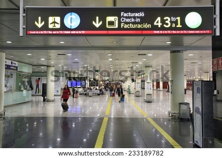 BARCELONA, SPAIN - NOVEMBER 6, 2012: Travelers visit El Prat airport in Barcelona, Spain. It is world\'s 35th busiest airport with 34 million passengers handled in 2011.
