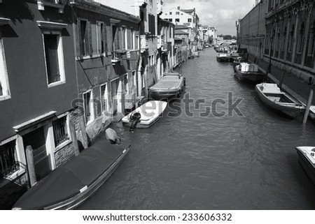 Canal in Venice. Old architecture, water and boats. Black and white tone - retro monochrome color style.