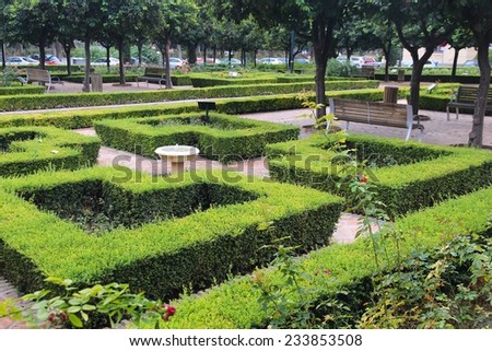 Malaga, Spain. City park decorations with trimmed hedge.