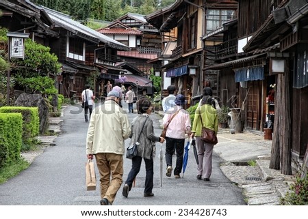TSUMAGO, JAPAN - MAY 2, 2012: People visit old town of Tsumago. Tsumago-juku was a historic post town of famous Nakasendo Kiso valley trail between Kyoto and Edo.