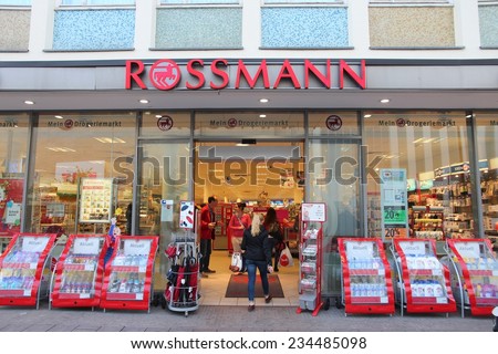 LUBECK, GERMANY - AUGUST 29, 2014: People visit Rossmann cosmetics store in Lubeck, Germany. As of 2011 Rossmann had 2,531 stores and 31,000 employees.