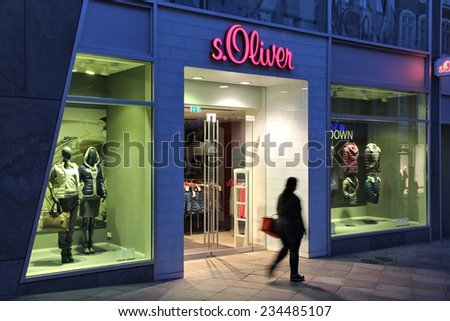 LUBECK, GERMANY - AUGUST 29, 2014: Person walks by s.Oliver fashion store in Lubeck, Germany. S.Oliver was founded in 1968 and as of 2011 employed about 7,000 people worldwide.