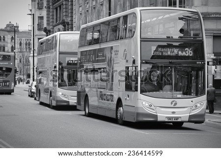 MANCHESTER, UK - APRIL 22, 2013: People ride FirstGroup city buses in Manchester, UK. FirstGroup employs 124,000 people.