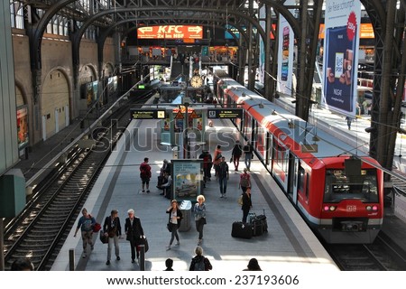HAMBURG, GERMANY - AUGUST 28, 2014: Travelers board the train at Central Railway Station (Hauptbahnhof) in Hamburg. With 450,000 daily passengers it is the 2nd busies station in Europe.