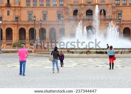SEVILLE, SPAIN - NOVEMBER 3, 2012: People visit Plaza de Espana in Seville, Spain. Seville is a major tourism destination in Spain with 4.8 million hotel-nights in 2011.