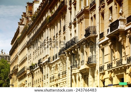 Paris, France - old apartment buildings street. Windows and balconies. Filtered style colors.