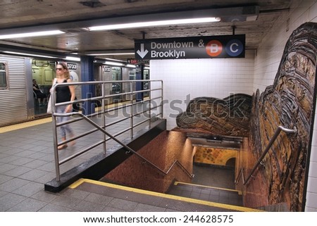 NEW YORK, USA - JULY 6, 2013: People exit train at Museum of Natural History subway station in NY. With 1.67 billion annual rides, New York City Subway is the 7th busiest metro system in the world.