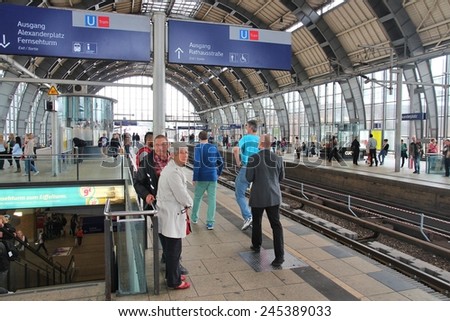 BERLIN, GERMANY - AUGUST 26, 2014: People wait at Alexanderplatz railway station in Berlin. The station dates back to 1882 and is one of 11 stations in Berlin that have long distance connections.