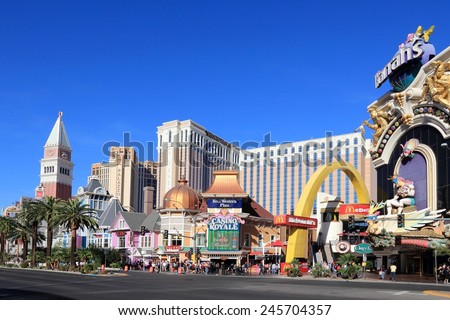 LAS VEGAS, USA - APRIL 14, 2014: People visit the famous Strip in Las Vegas. 15 of 25 largest hotels in the world are located at the strip with more than 60 thousand rooms.