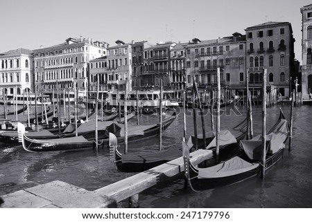 Canal Grande and gondolas - passenger transportation boats typical for Venice, Italy. Black and white tone - retro monochrome color style.