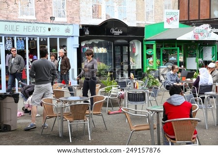LONDON, UK - MAY 13, 2012: People visit quirky stores in Gabriel\'s Wharf, London. Gabriel\'s Wharf was recently redeveloped into hip alternative shopping destination.