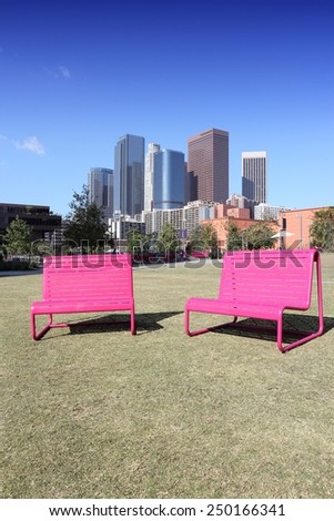 Los Angeles, California, United States. City skyline view with pink park chairs.