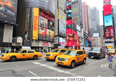 NEW YORK, USA - JULY 3, 2013: Taxis drive along Times Square in New York. Times Square is one of most recognized landmarks in the USA. More than 300,000 people visit Times Square every day.
