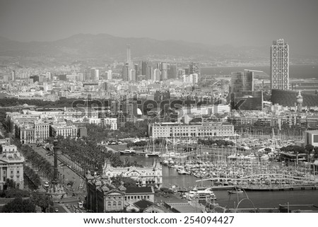 Barcelona cityscape. View seen from Montjuic. Port Vell, marina and other buildings. Black and white tone.