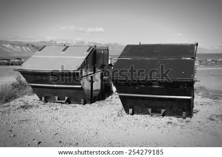 Large waste dumpsters in Snaefellsnes peninsula, Iceland. Black and white tone.