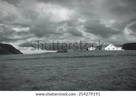 Iceland countryside landscape - generic farm house. Black and white toned image.
