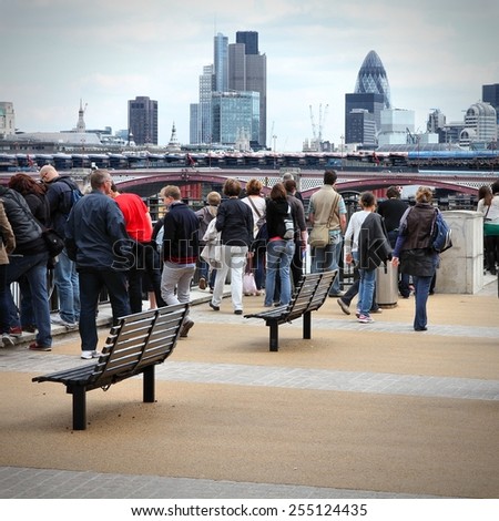 LONDON, UK - MAY 13, 2012: Tourists visit Thames Embankment in London. With more than 14 million international arrivals in 2009, London is the most visited city in the world (Euromonitor).