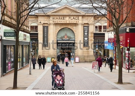 BOLTON, UK - APRIL 23, 2013: People walk along a shopping street in Bolton, UK. Bolton is part of Greater Manchester, one of largest population areas in the UK (2.68m people living in the county).