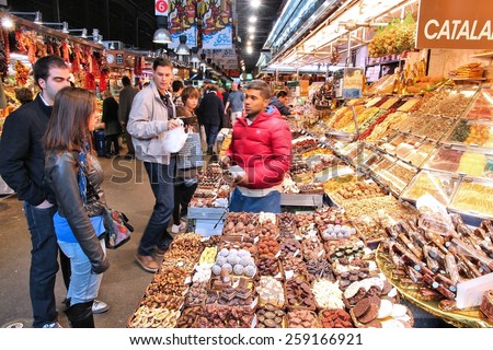 BARCELONA, SPAIN - NOVEMBER 6, 2012: People visit Boqueria market in Barcelona, Spain. Tripadvisor says it is best shopping destination in Barcelona, the most visited city in Spain.