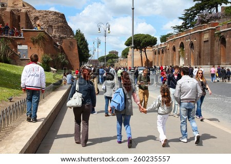 ROME, ITALY - APRIL 10, 2012: Tourists visit Via Fori Imperiali in Rome. According to official data Rome was visited by 12.6 million people in 2013.