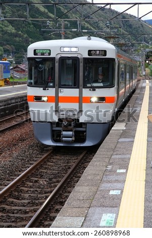NAGISO, JAPAN - MAY 2, 2012: Central Japan Railway Company electric train of 313 series arrives at Nagiso station. JR Central had 134 billion JPY in net income for 2011.